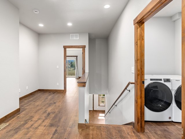 Property Photo 22 Upper level hallway with conveniently located laundry room. Office/flex space at top of stairs.