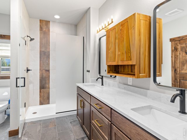 Property Photo 16 Primary bathroom Has beautifully tiled walk in shower and dual sinks