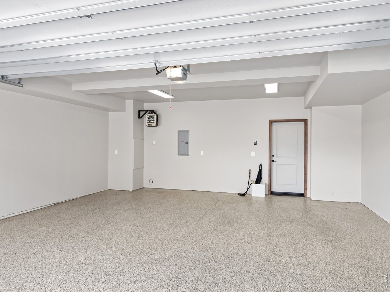 Property Photo 24 Finished, heated, attached two-car garage with epoxy floor, ensuring both convenience and security for your vehicles.