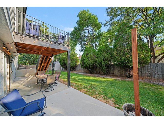 Property Photo 32 Expansive concrete lower patio sheltered by the deck above, perfect for outdoor dining and entertaining.