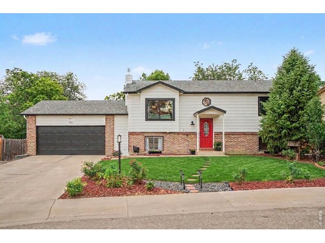 Property Photo 43 Beautifully maintained split-level with a modern facade, iconic red door, and a spacious two-car garage.