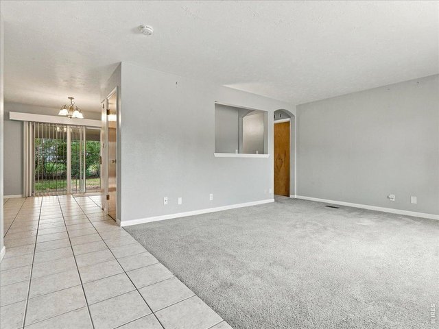Property Photo 3 tile floor from entry to dining area and patio slider