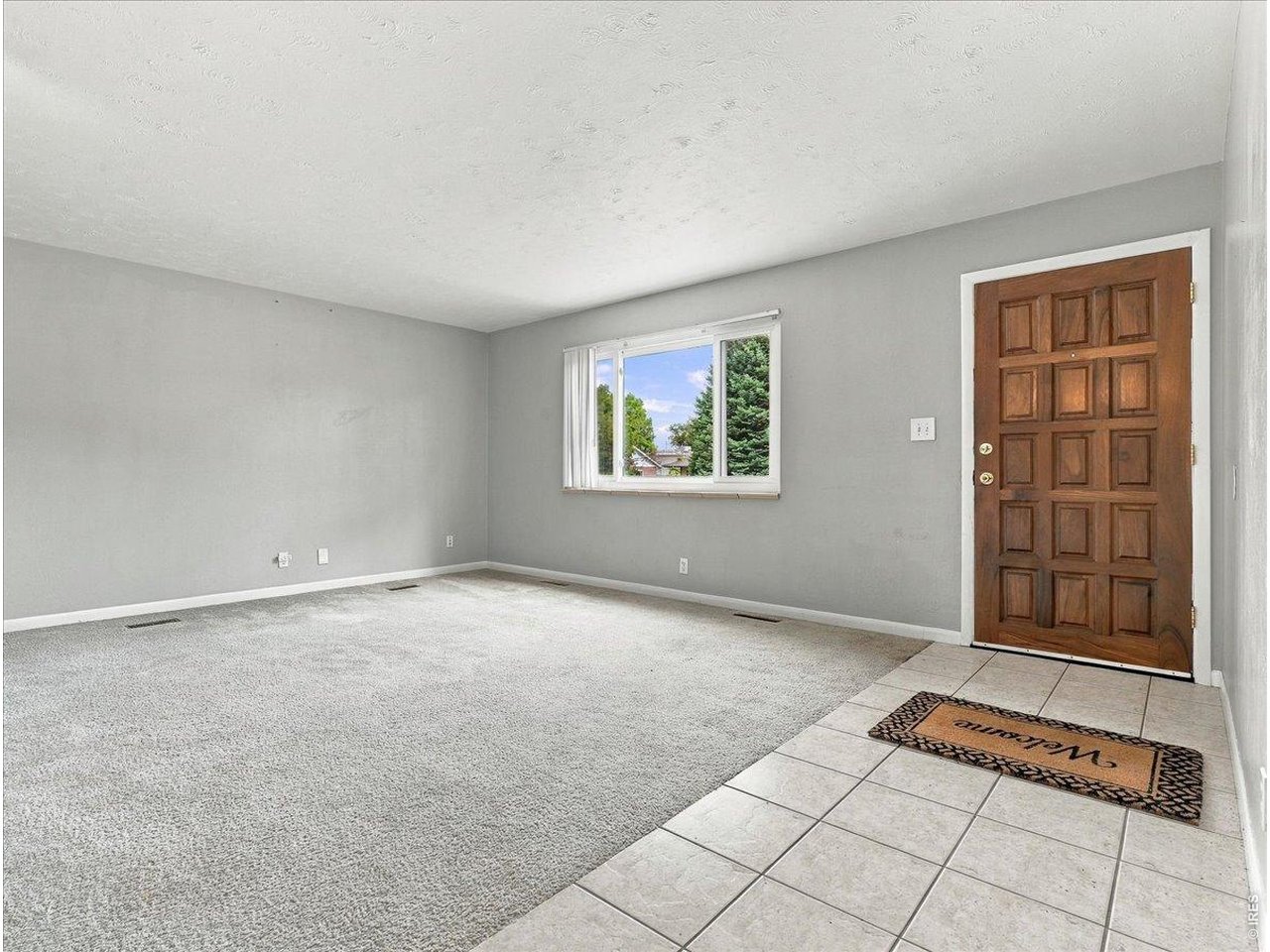 Property Photo 1 Living room ...Oak floors and tile entry to dinning room and kitchen under carpet Note newer vinyl double pane windows