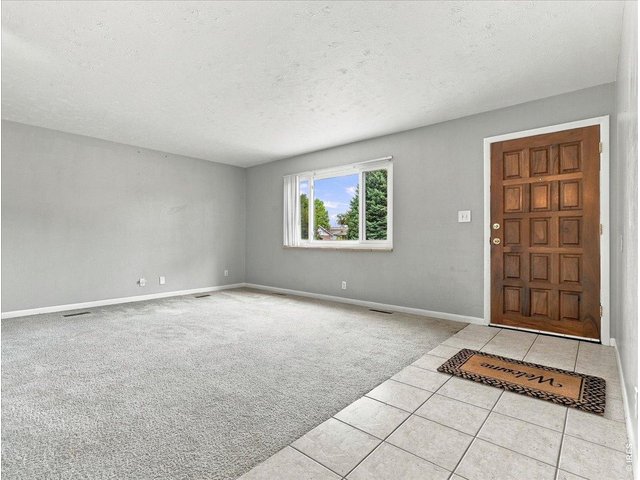 Property Photo 1 Living room ...Oak floors and tile entry to dinning room and kitchen under carpet Note newer vinyl double pane windows