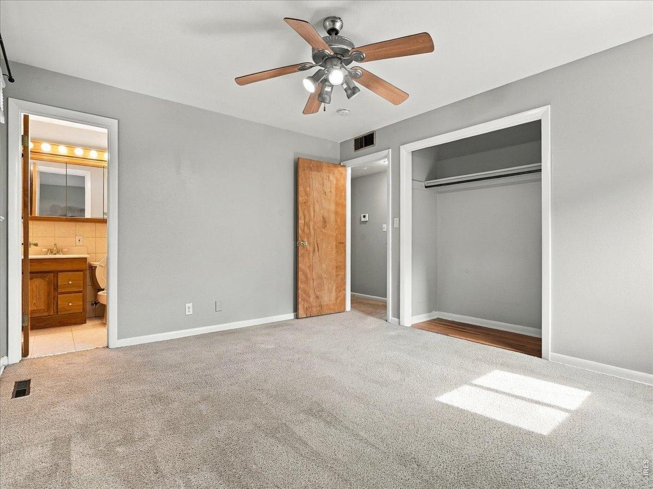 Property Photo 11 primary bedroom with 1/2 bath note oak floor under carpet