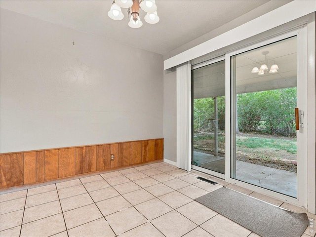 Property Photo 5 dining area with slider to large, covered patio and yard