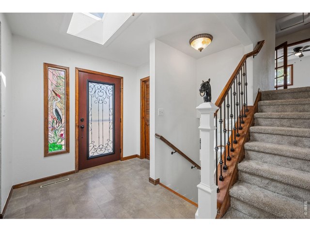 Property Photo 3 Entryway with beautiful stained-glass accents.