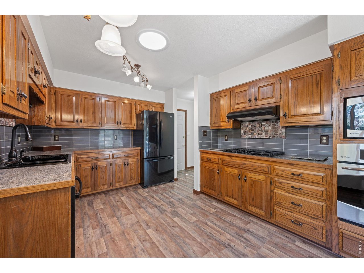 Property Photo 8 Kitchen with gas cooktop.