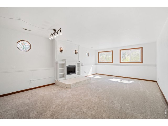 Property Photo 12 Lower-level living room with cozy electric fireplace.