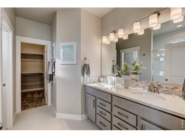 Property Photo 7 Primary bathroom with dual vanities. Finishes may vary.
