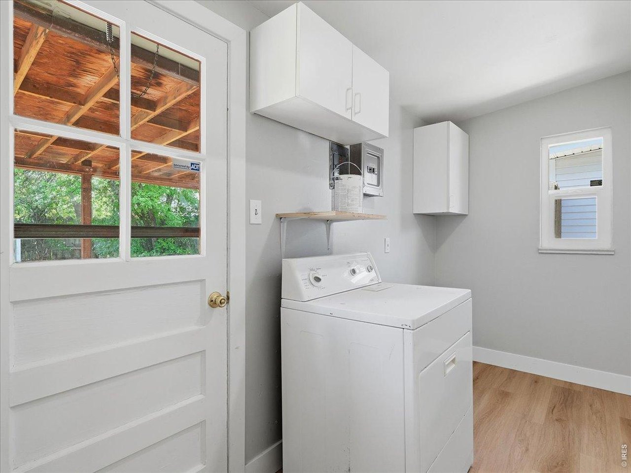 Property Photo 29 mud room with dryer, exterior door to covered patio, wonderful built-in storage cabinets and drawer across from the dryer notice the original copper hardware.