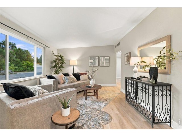 Property Photo 2 Living room, note newer vinyl windows and luxury Cementous tile plank floor and interior paint
