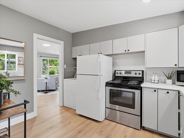 Property Photo 14 Kitchen newer clean lined cabinets, washer is located to the left of the refrigerator in the kitchen