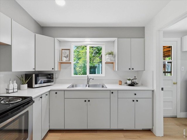Property Photo 12 Kitchen, see entry to mudroom to the right and exterior door to covered patio