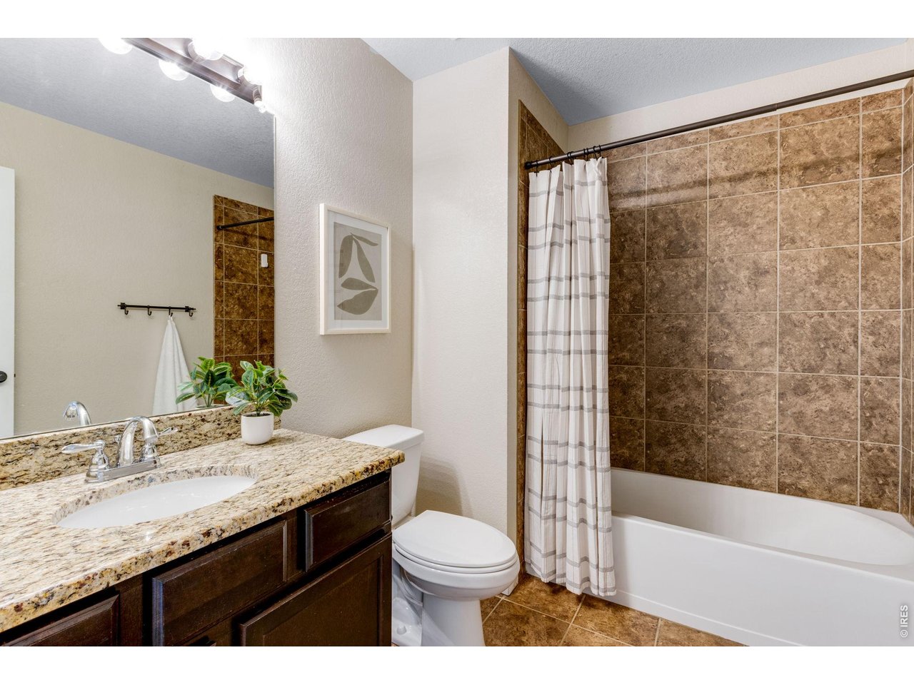 Property Photo 29 Secondary Full bathroom, granite countertops and beautiful warm tile work.