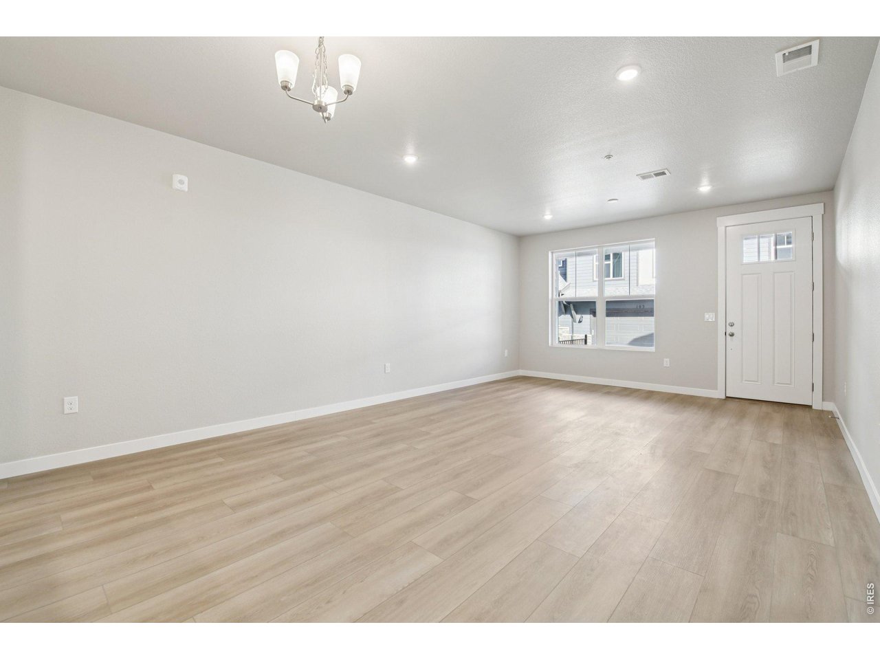 Property Photo 4 Upgraded, extended luxury vinyl into living room.