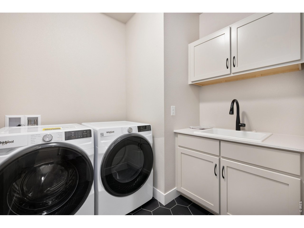 Property Photo 10 Main floor laundery with built in upgraded cabinets and sink
