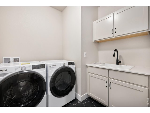 Property Photo 10 Main floor laundery with built in upgraded cabinets and sink