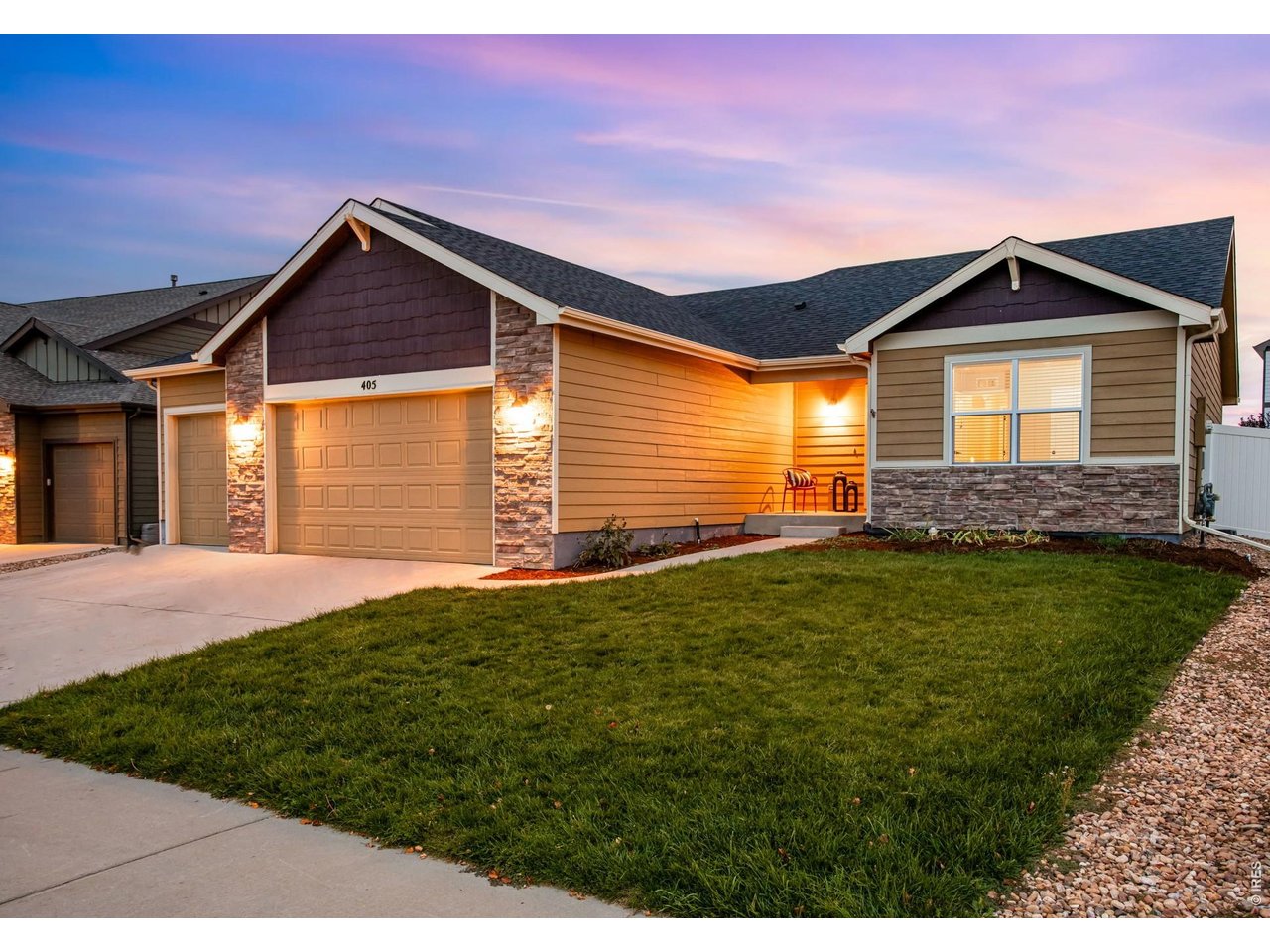 Property Photo 5 Lush green yard, fresh mulch, pretty stone exterior & large picture windows! Sunset Ridge is one of the few communities in Severance without a Metrodistrict!  Low reasonable HOA at $45/ month