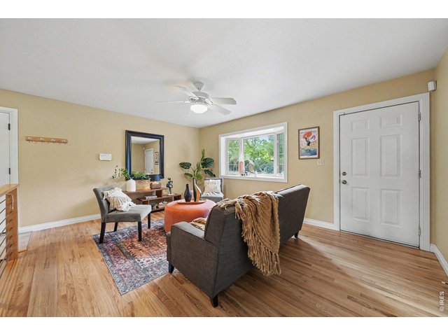 Property Photo 5 Hardwood floor and BIG BRIGHT BAY window in living room.