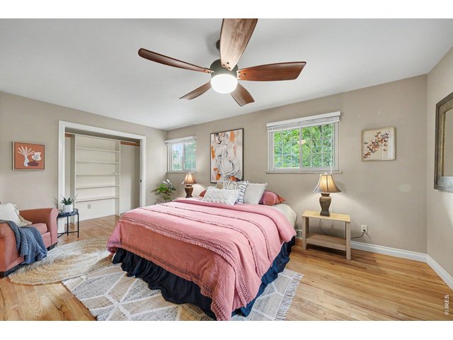Property Photo 11 Oversized primary bedroom - hardwood floors.