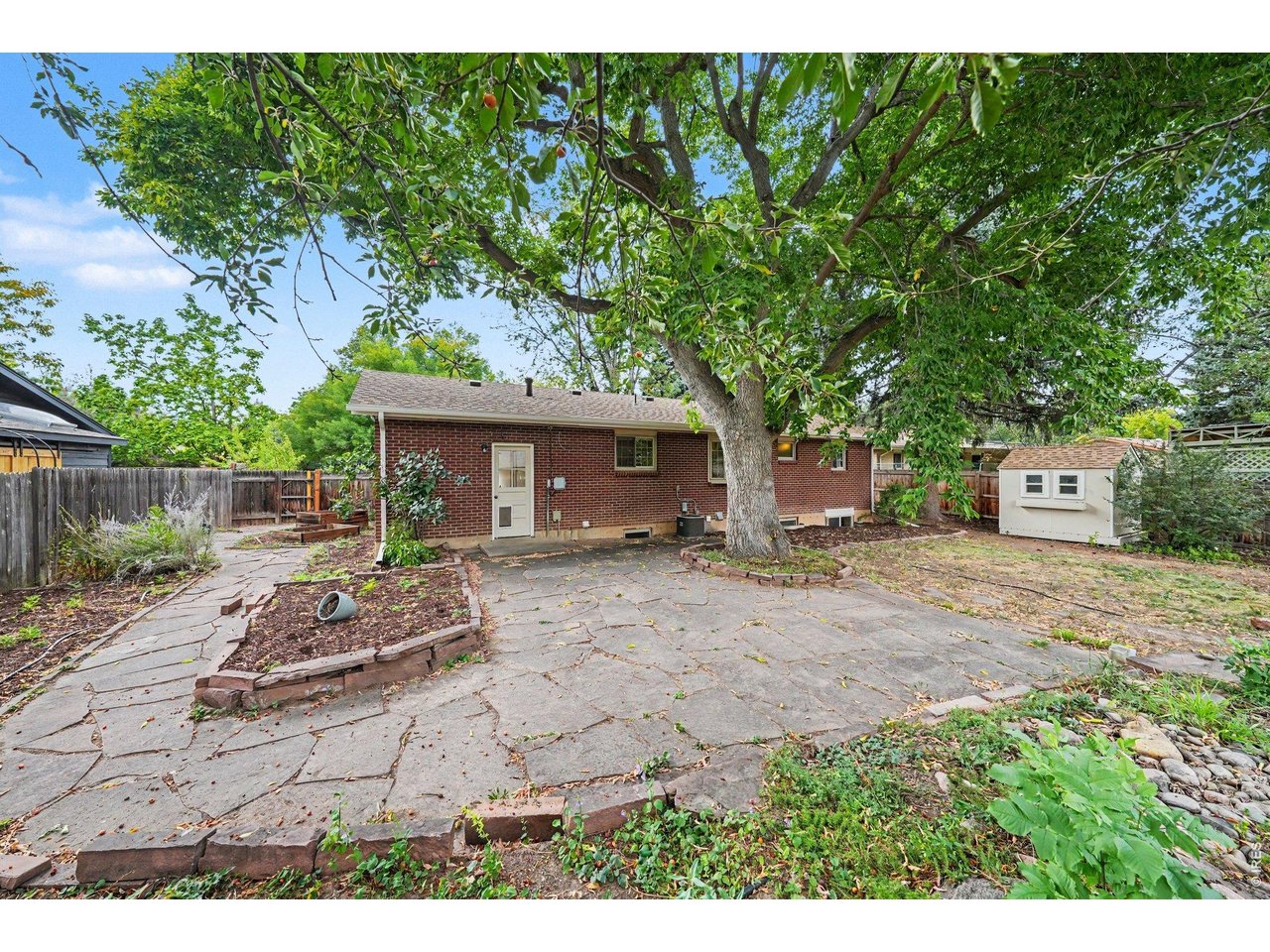 Property Photo 27 Backyard with Huge Flagstone Patio & "Planty" of Gardening Potential