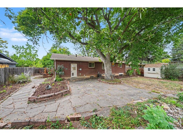 Property Photo 27 Backyard with Huge Flagstone Patio & "Planty" of Gardening Potential