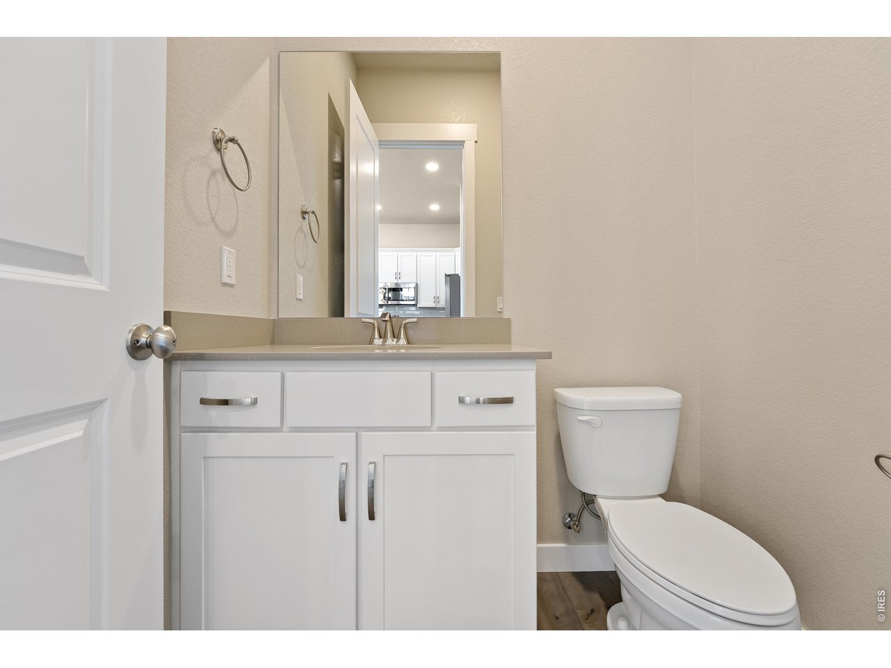 Property Photo 10 Main floor powder room. Finishes may vary.