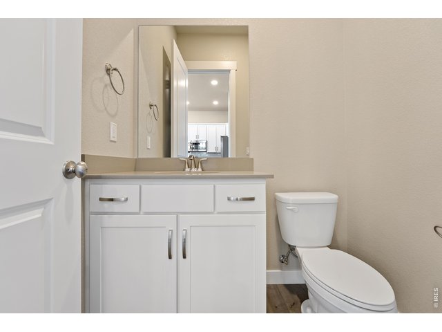 Property Photo 10 Main floor powder room. Finishes may vary.