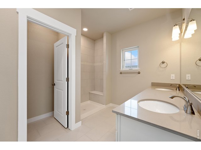 Property Photo 15 Primary bathroom with dual vanities. Finishes may vary.