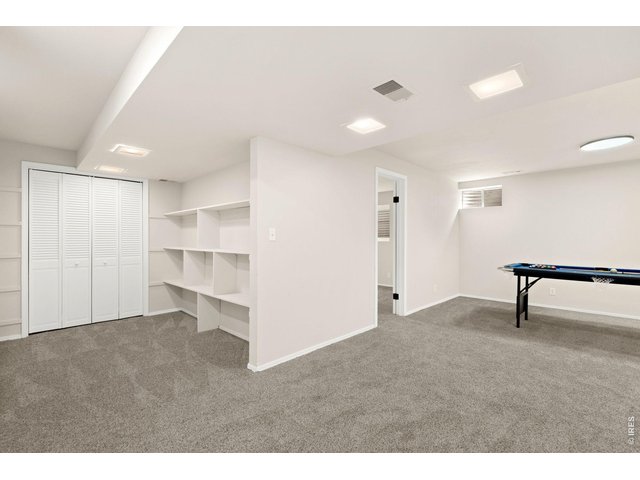 Property Photo 18 Basement recreation room with lots of shelves!