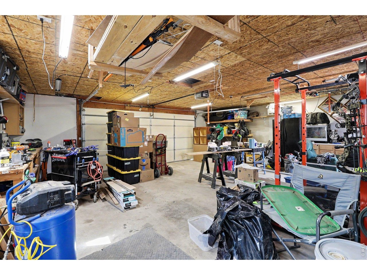Property Photo 19 Oversized, insulated detached garage that is perfect for a workshop or hobby space, complete with 220-volt service. The pellet stove efficiently heats the garage, creating a comfortable year-round workspace.