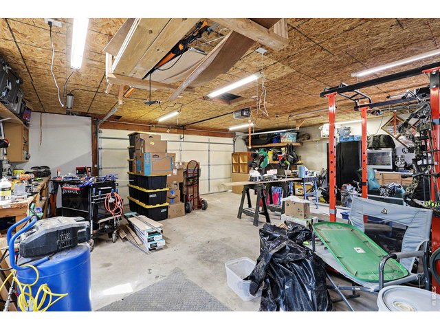 Property Photo 19 Oversized, insulated detached garage that is perfect for a workshop or hobby space, complete with 220-volt service. The pellet stove efficiently heats the garage, creating a comfortable year-round workspace.
