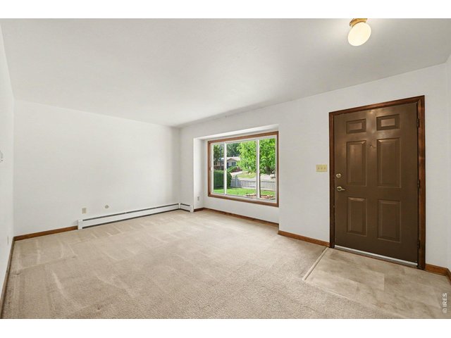 Property Photo 4 Bright front room.
