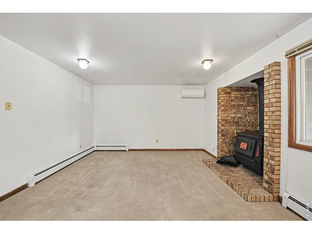 Property Photo 10 Cozy dining/entertainment area with both AC and a true wood burning stove.