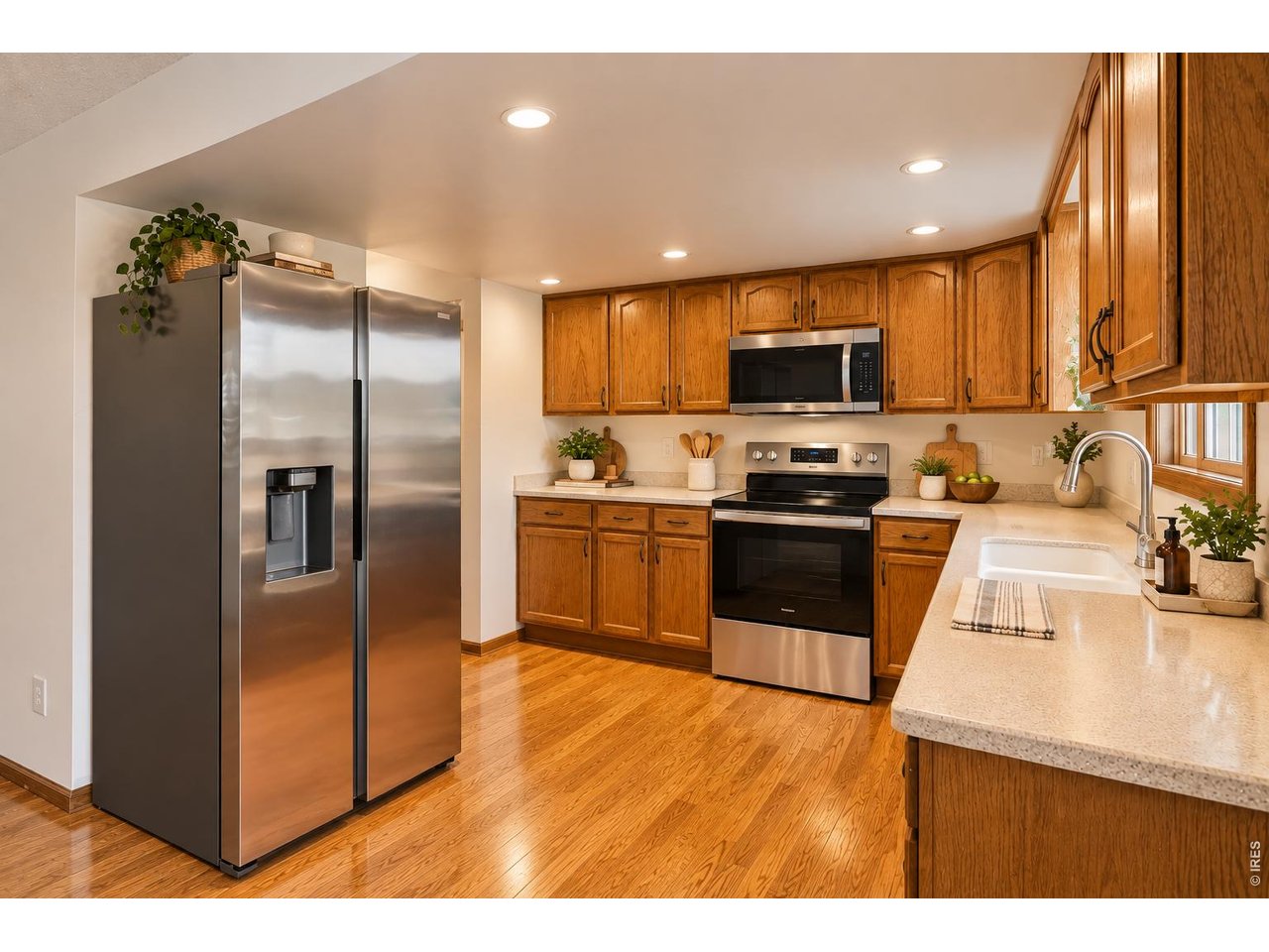Property Photo 14 Kitchen with brand new range and microwave. Corian countertops.