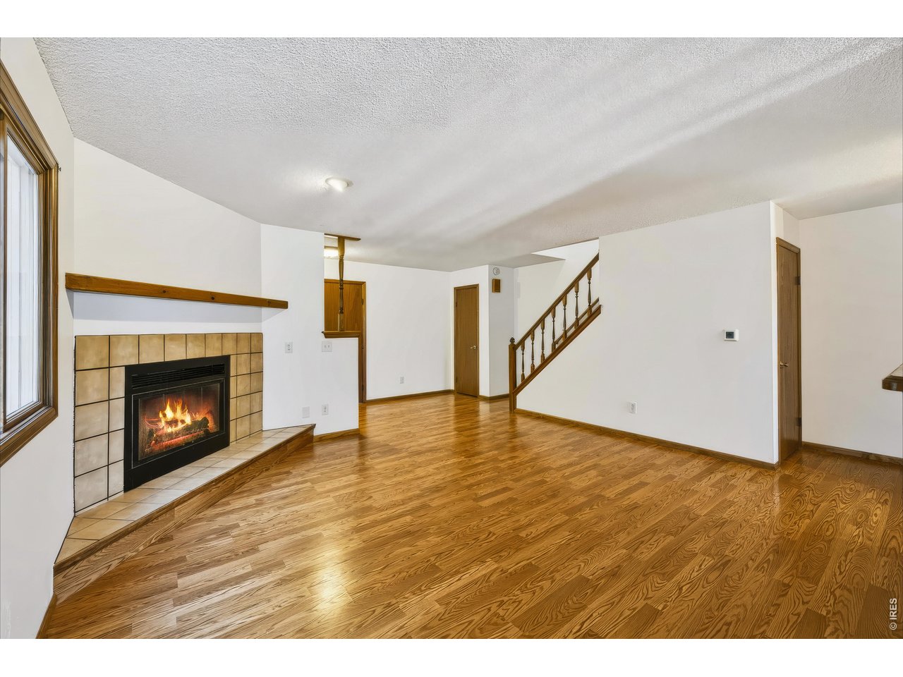 Property Photo 11 Large living room with wood-burning fireplace.