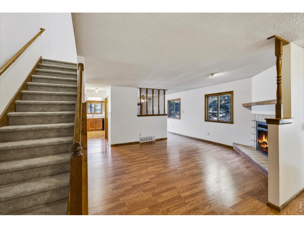 Property Photo 9 Spacious living room with wood-burning fireplace.