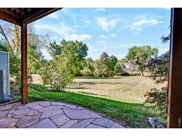 Property Photo 4 Flagstone patio with a retractable sun shade opens to the private meadow park. (No public access to the meadow)