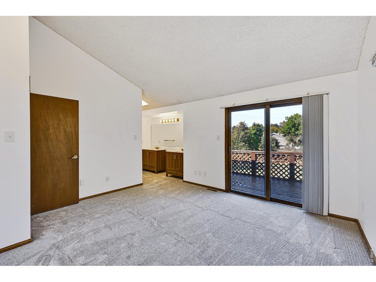 Property Photo 18 Primary Suite leads to the west-facing balcony.