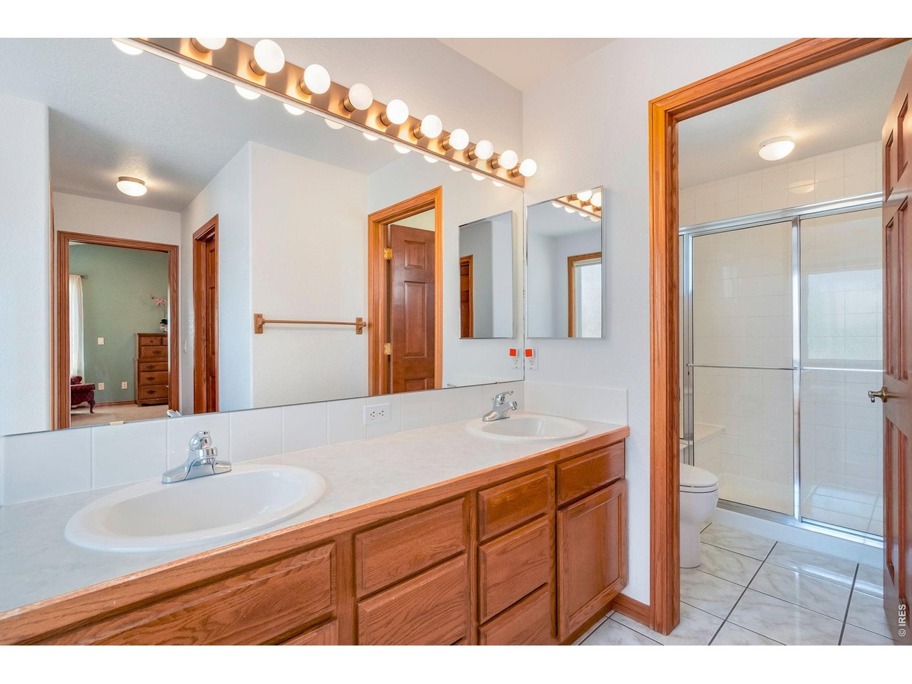 Property Photo 25 Main floor primary bedroom retreat featuring a private en-suite bathroom and walk-in closet