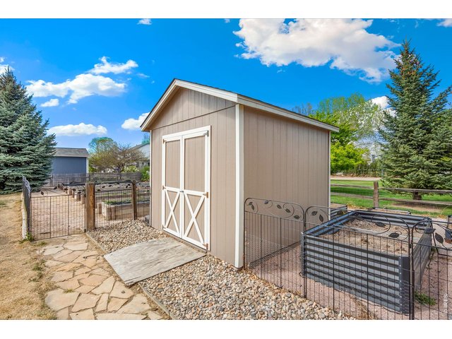 Property Photo 46 Extra storage for your garden toys and outdoor equipment, perfectly situated to maintain the pristine look of your spacious 1/2 acre backyard.