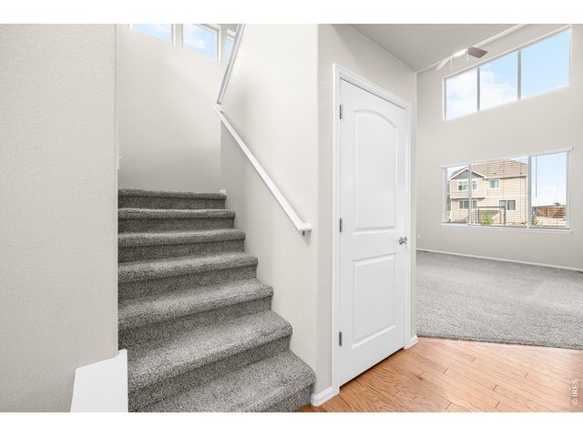 Property Photo 8 Inviting Entry Way with real Hardwood Floors and Soaring Vaulted Ceiling