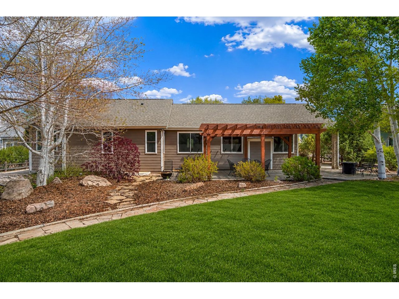 Property Photo 5 Large 1/2 acre backyard with 10 raised garden beds, a drip irrigation system, and a charming bungalow, making gardening easy and enjoyable