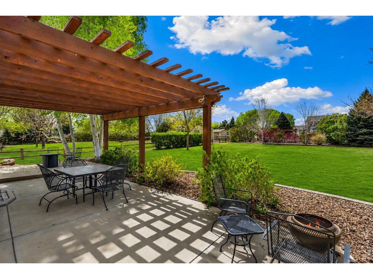 Property Photo 6 Large 1/2 acre backyard with 10 raised garden beds, a drip irrigation system, and a charming bungalow, making gardening easy and enjoyable