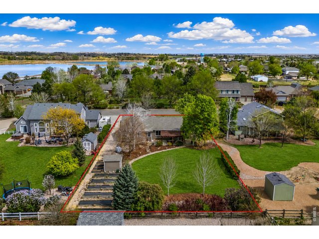 Property Photo 4 Large 1/2 acre backyard with 10 raised garden beds, a drip irrigation system, and a charming bungalow, making gardening easy and enjoyable