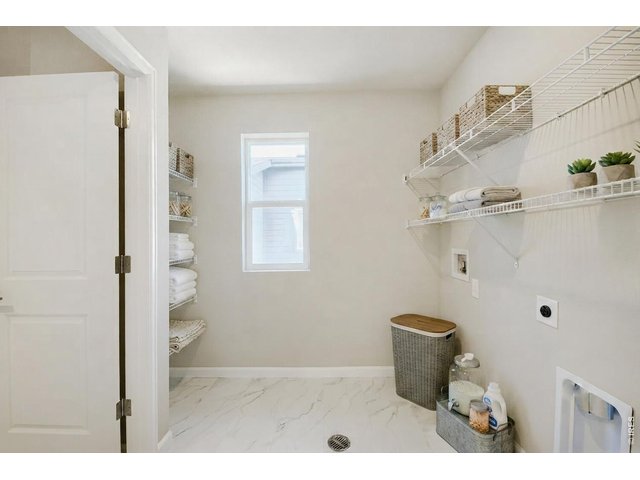 Property Photo 20 Upstairs Laundry with Access Door to Primary Closet