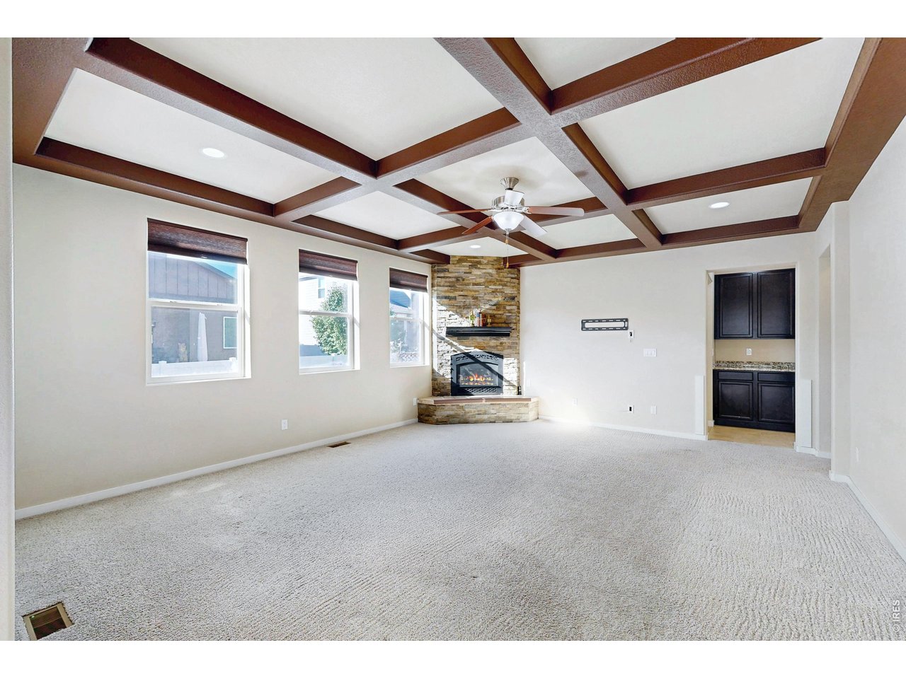 Property Photo 12 Living room w/ ceiling beams and tons of light