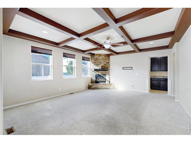 Property Photo 12 Living room w/ ceiling beams and tons of light