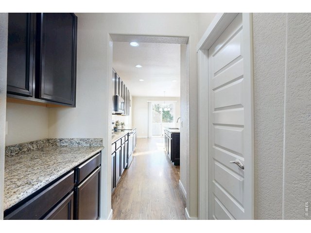 Property Photo 10 Walk-through to pantry and butler's pantry area leading to formal dining
